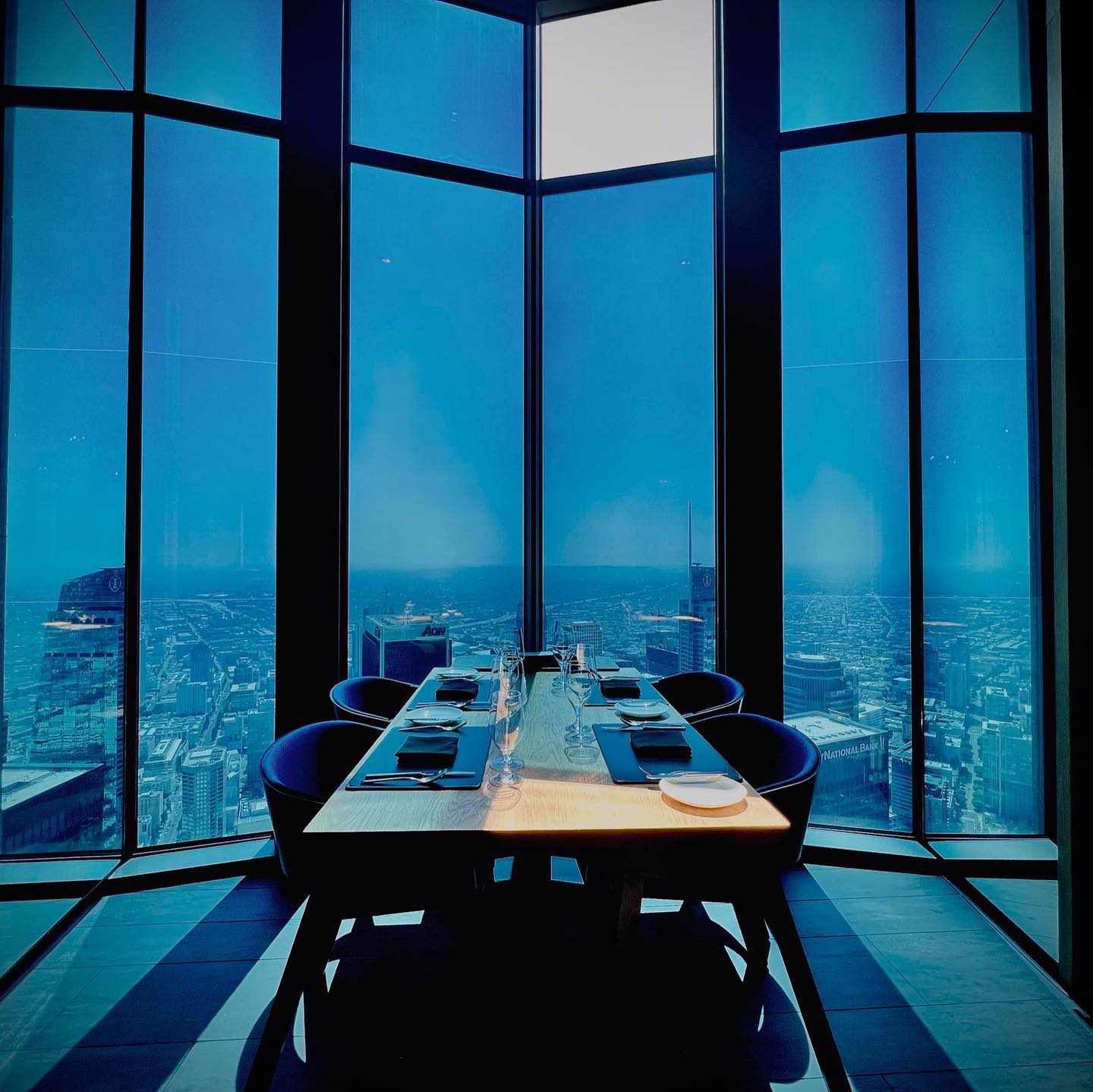 Natural lighting casts a faint blue hue on the floor-to-ceiling window glass of 71Above in Los Angeles