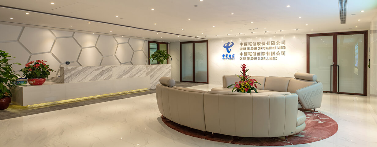 Receiving area of China Telecom , with semi-circular tan-colored leather couch at the middle and hexagon wall design