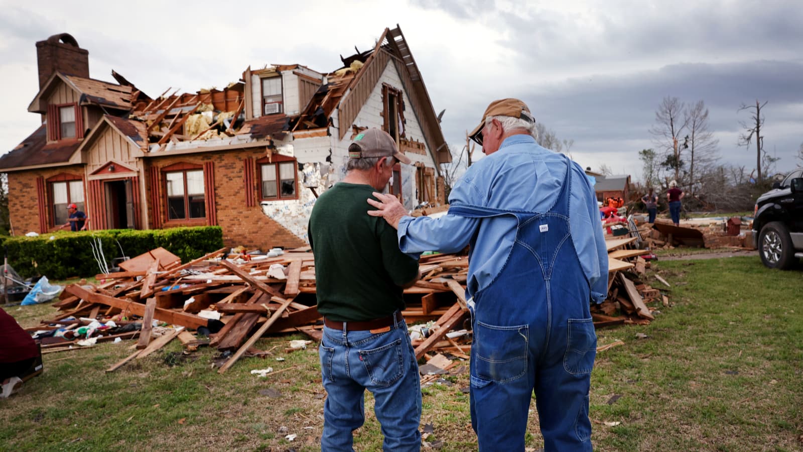 One man consoling other after the house destroyed due to tornado