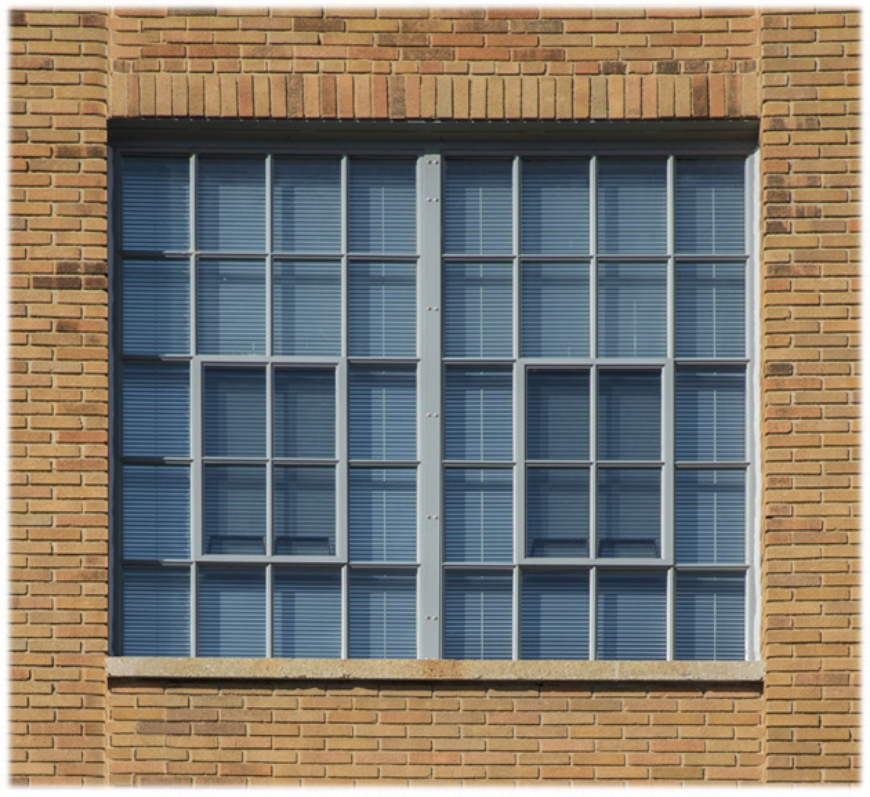 Steel replication window on a brick wall
