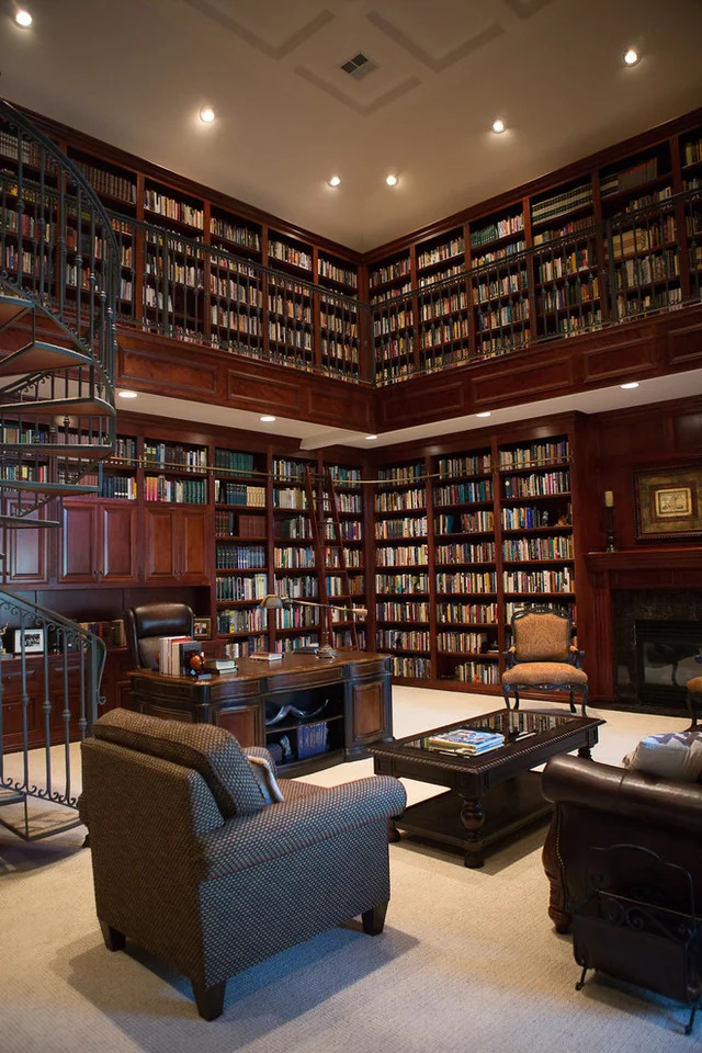 Double height home office library with a fire place
