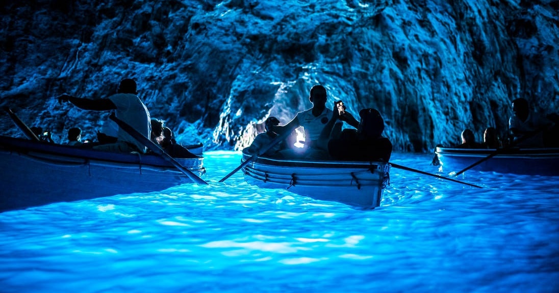 People on a boat in a Blue Grotto